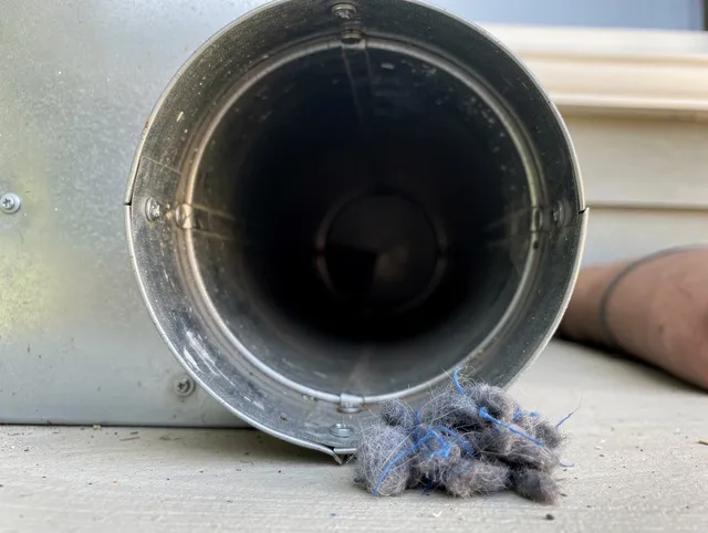 Oxford Dryer Vent Cleaning technician using specialized equipment to clear severe dryer vent blockage in Oxford